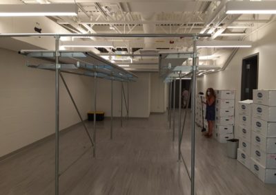 Railex System 200 installed for costume storage in a tight space. We included a shelving system on top for folded items.  This system is completely free standing with our end-frame and header design.