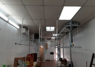 Railex 742 conveyor and slick rail installed in a dry cleaner. We maximized the space with our two tier conveyor and ceiling suspended slick rail system.