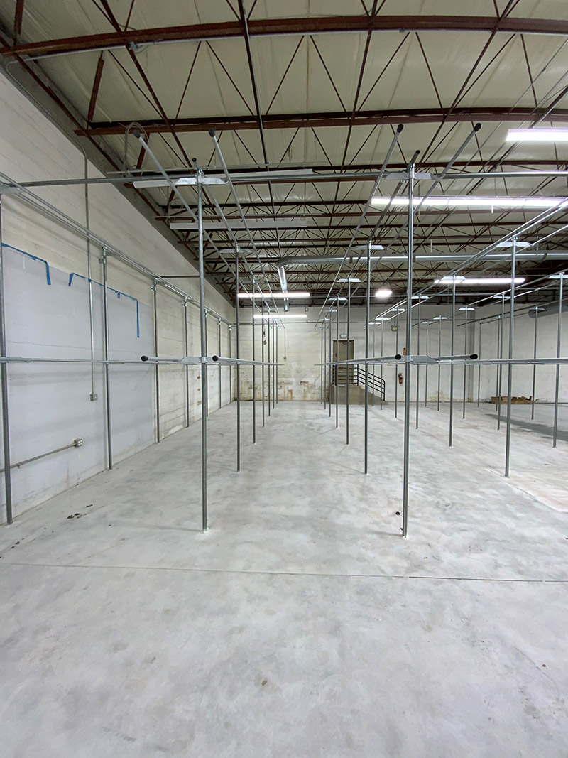 Railex System 200 Slick Rail newly installed in a garment restoration storage facility. This slick rail is system 12’ tall and is double tier. When filled it will maximize the cubic space of this 1,600 square foot space with room for about 10,000 garments.