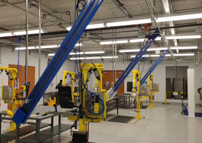 Railex System 520 Lifting conveyors set up at inspection stations. The 520 conveyors are at 60 degrees. Once the highly specialized garments are inspected the 520 conveyors lift and then transfer the garments onto a Railex System 420 pin conveyor.