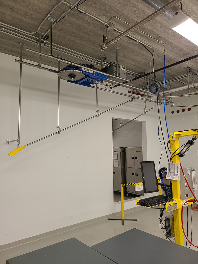 Railex System 420 Pin Conveyor Pneumatic Transfer for taking garments off the line and onto slick rail. The Pneumatic transfer is activated by a system that automatically inspects the garment and then signals the system where to dispatch the garment.