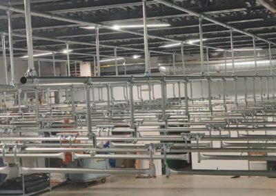 Railex System 200 Trolley Storage area under construction. This trolley storage area is ceiling suspended and comes out from underneath a mezzanine. This area features 20 trolley storage lines. The lines, when complete, will feed directly into the loading dock. Trolleys move into the trucks with Railex telescopic switches that join the rail system in the building to the rail system inside the trucks and vans.